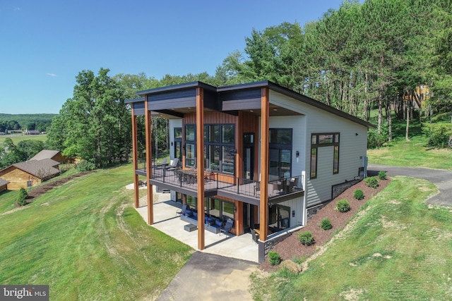 view of front facade with a front lawn and a deck