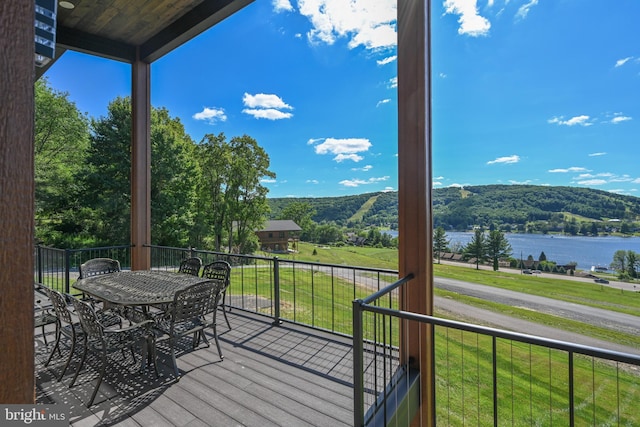 wooden terrace featuring a yard and a water and mountain view