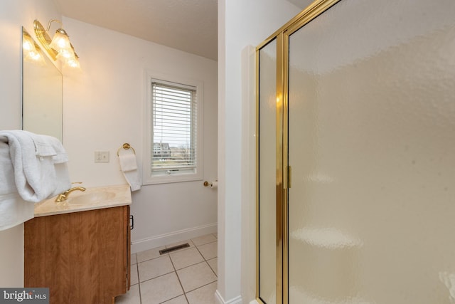 bathroom featuring tile patterned flooring, vanity, and an enclosed shower