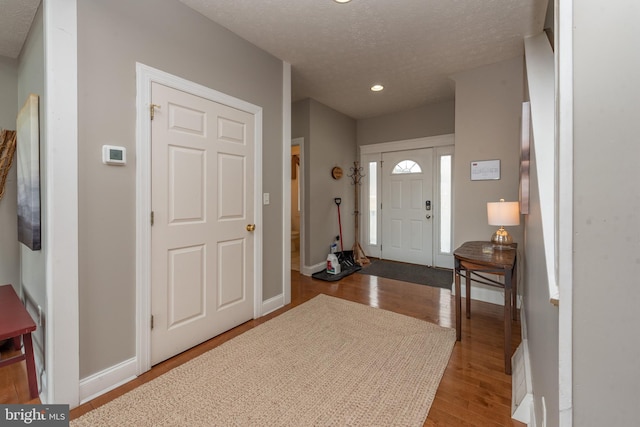 foyer with a textured ceiling and hardwood / wood-style flooring