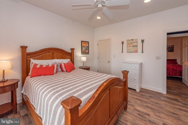 bedroom with dark hardwood / wood-style floors and ceiling fan