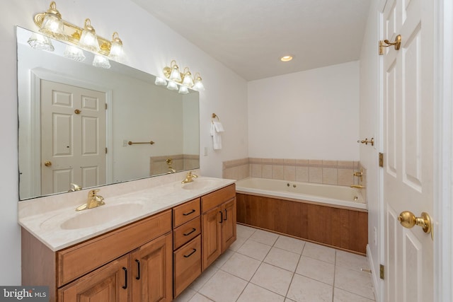 bathroom with a bath, vanity, and tile patterned floors