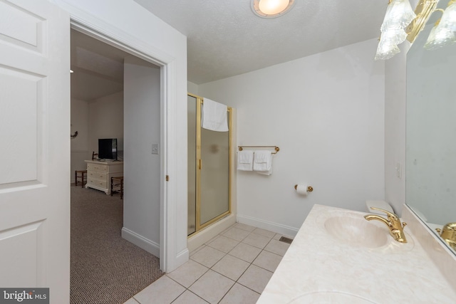 bathroom featuring vanity, tile patterned floors, and a shower with door