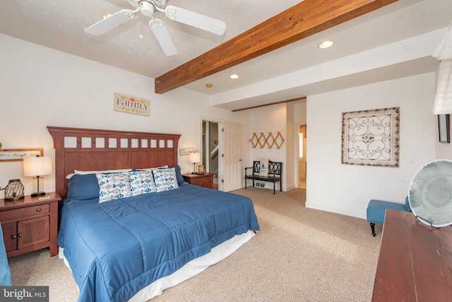 carpeted bedroom with ceiling fan, beam ceiling, and a textured ceiling