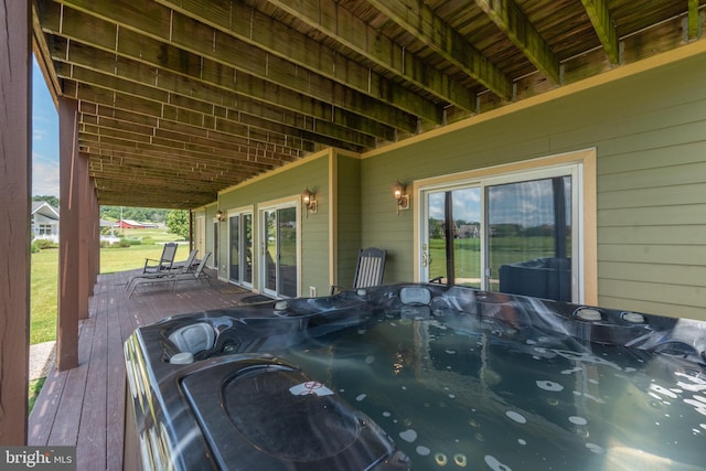 wooden deck with a hot tub