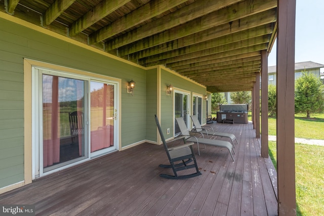 wooden terrace featuring a hot tub and grilling area