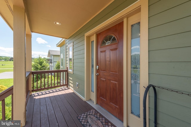 view of exterior entry featuring covered porch