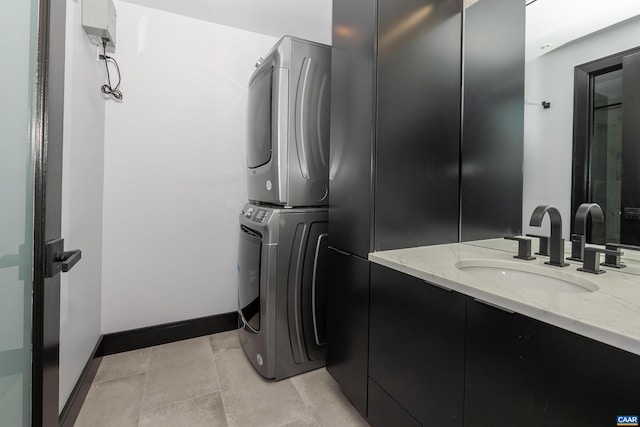 bathroom with vanity and stacked washing maching and dryer