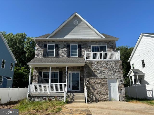 view of front of house with a balcony and covered porch