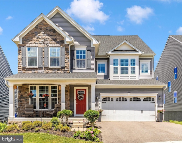 craftsman inspired home featuring a garage and a porch