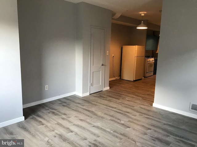 spare room featuring hardwood / wood-style floors