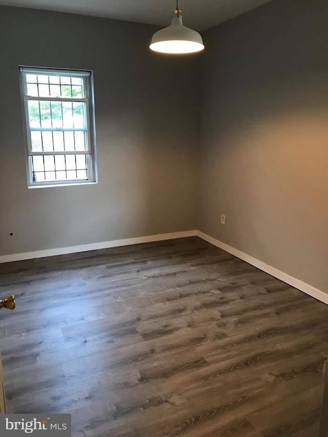 spare room with dark hardwood / wood-style flooring