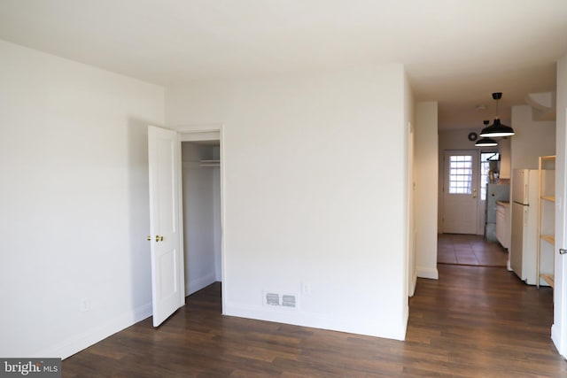 unfurnished room featuring dark hardwood / wood-style flooring