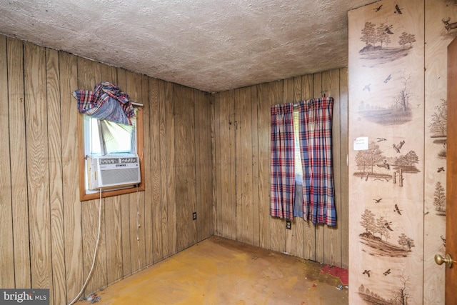 spare room with cooling unit and wooden walls