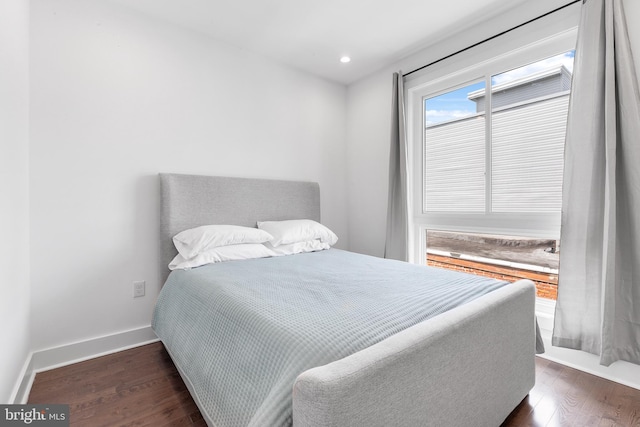 bedroom with dark wood-type flooring