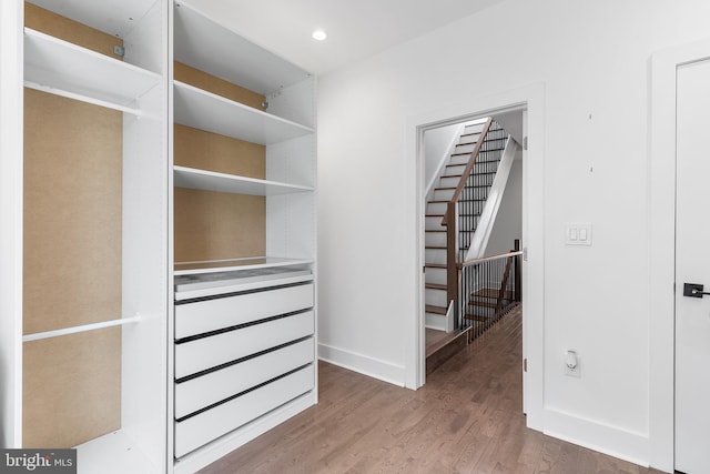 walk in closet with hardwood / wood-style flooring