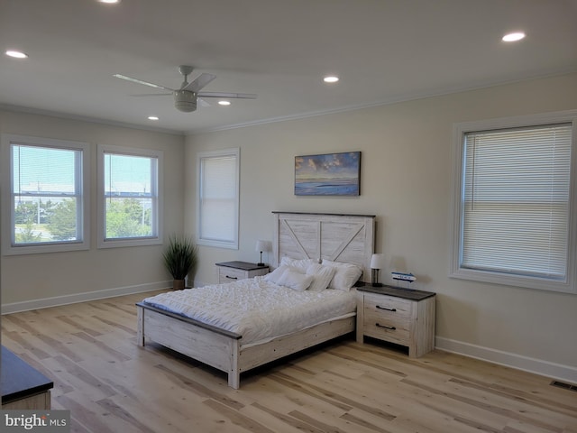 bedroom with ceiling fan, crown molding, and light hardwood / wood-style flooring