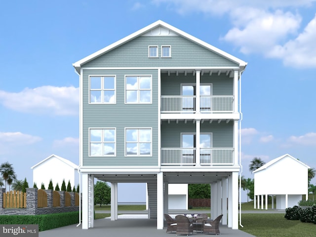 view of front of property with a carport, a patio, and a front lawn