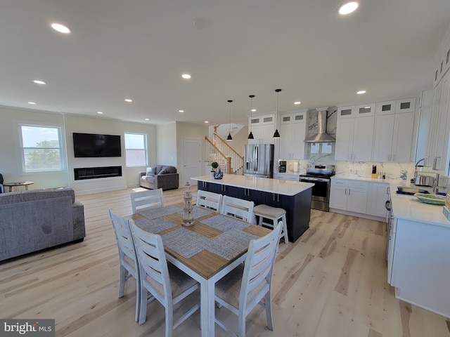 dining space with sink and light hardwood / wood-style floors