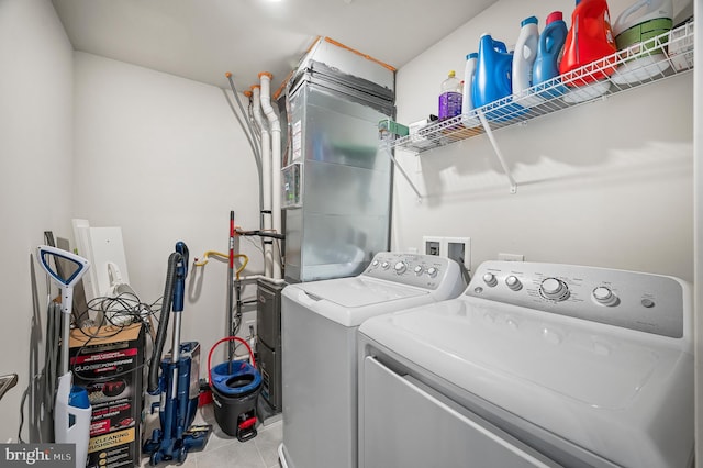 washroom with washer and dryer and light tile patterned flooring