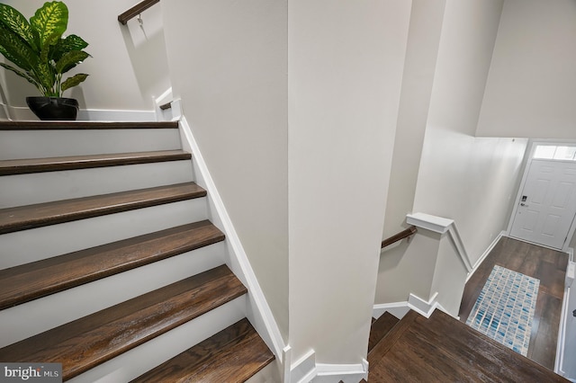 stairway with hardwood / wood-style flooring