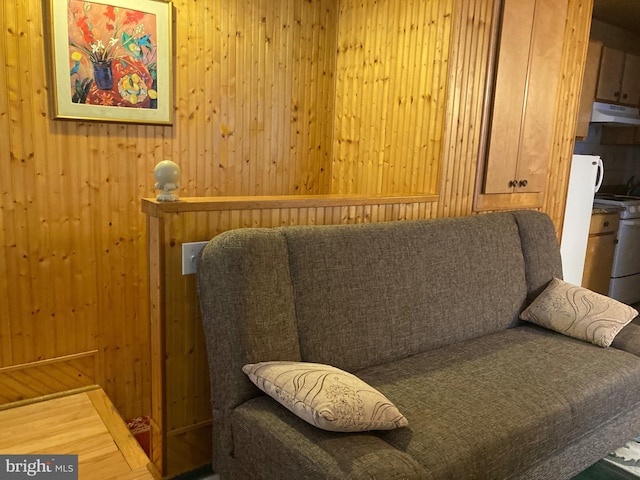 living area featuring wood walls and wood-type flooring