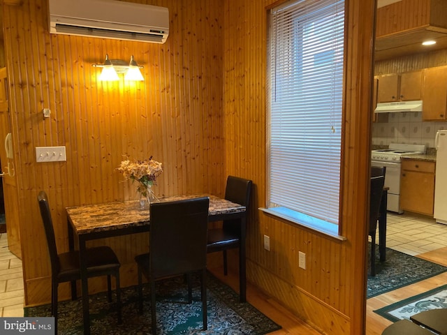 dining space featuring a wall mounted air conditioner and wooden walls