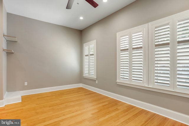 spare room with ceiling fan and hardwood / wood-style flooring