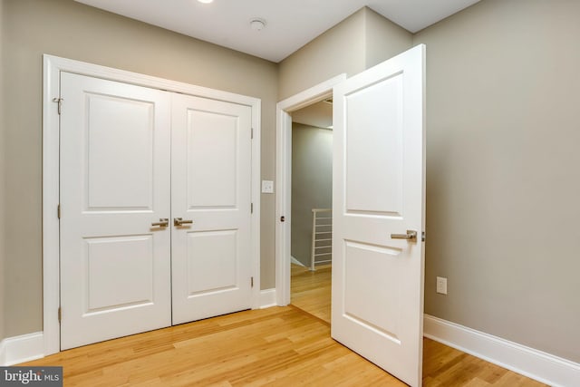 unfurnished bedroom with hardwood / wood-style flooring and a closet