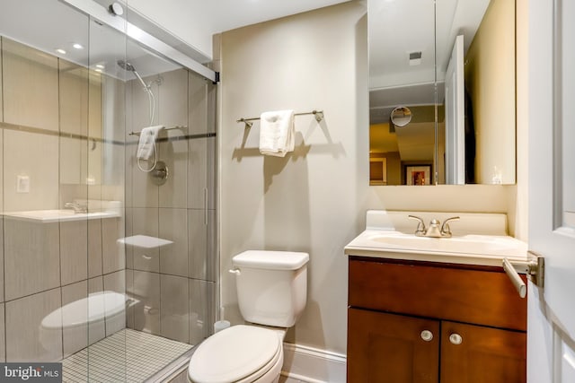 bathroom with vanity, toilet, and an enclosed shower