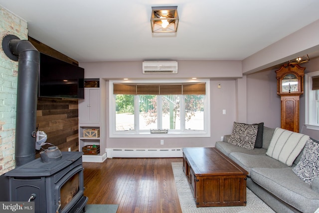 living room with dark wood-type flooring, baseboard heating, a wall mounted AC, and a wood stove