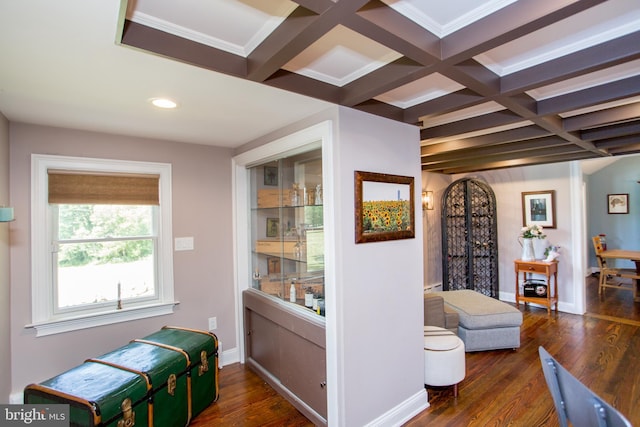 interior space featuring coffered ceiling, beamed ceiling, and dark hardwood / wood-style floors