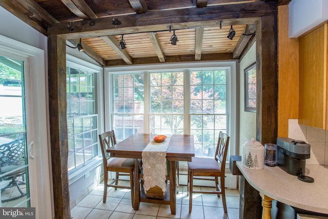 sunroom / solarium featuring vaulted ceiling with beams and wood ceiling