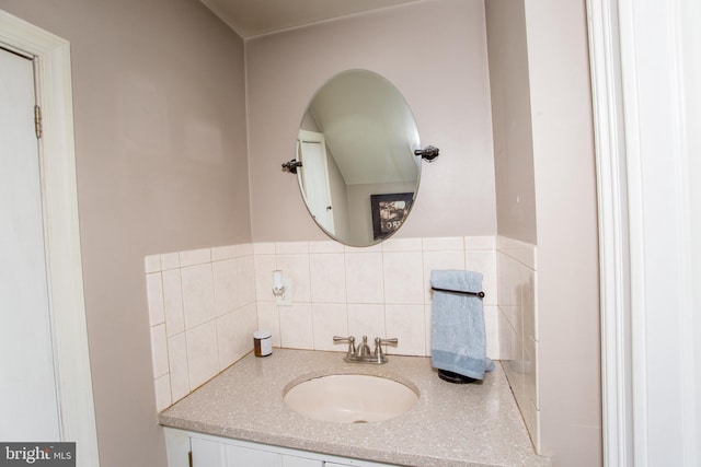 bathroom with tasteful backsplash and vanity