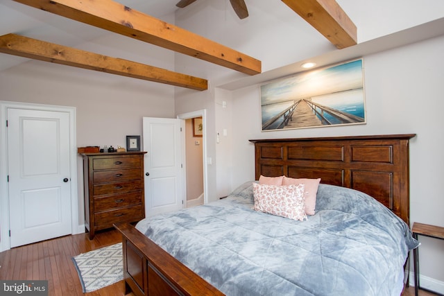 bedroom featuring beam ceiling, ceiling fan, and hardwood / wood-style flooring