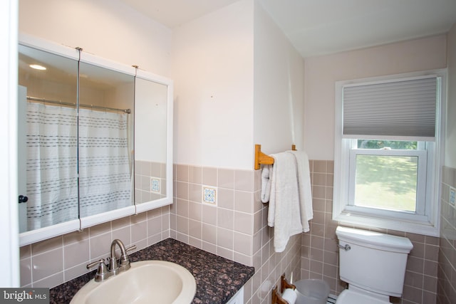 bathroom featuring sink, tile walls, toilet, and tasteful backsplash