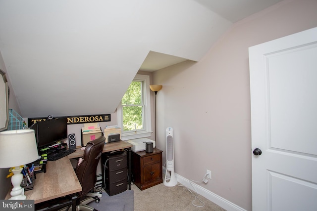 carpeted office featuring vaulted ceiling