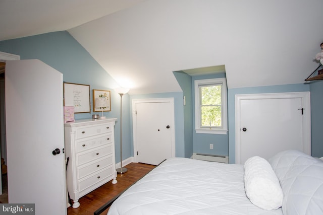 bedroom with hardwood / wood-style flooring, baseboard heating, and lofted ceiling