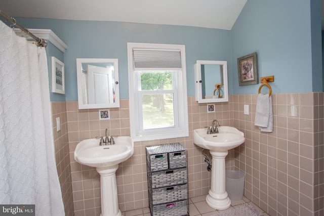 bathroom with tile patterned floors, decorative backsplash, and tile walls