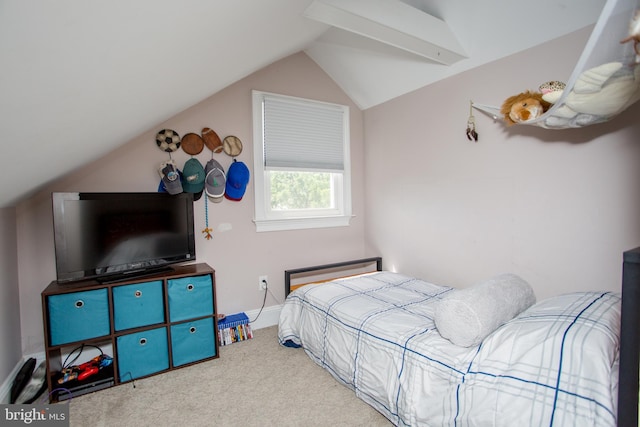 bedroom with carpet floors and vaulted ceiling with beams