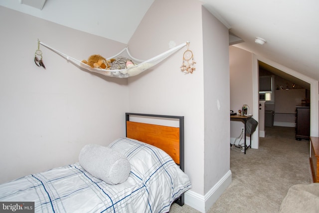 carpeted bedroom with vaulted ceiling