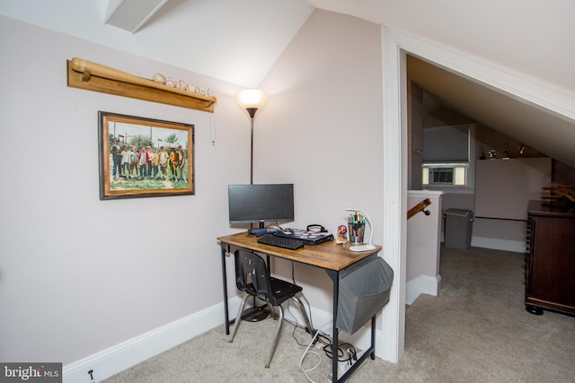 carpeted home office featuring lofted ceiling