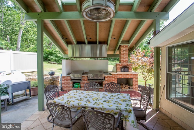 view of patio / terrace featuring area for grilling and an outdoor living space with a fireplace