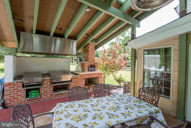 view of patio with exterior kitchen, area for grilling, and a fireplace