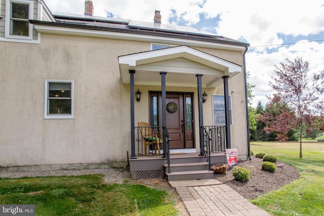 view of front of home with a porch and a front yard