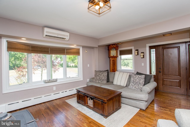 living room with hardwood / wood-style floors, an AC wall unit, and baseboard heating