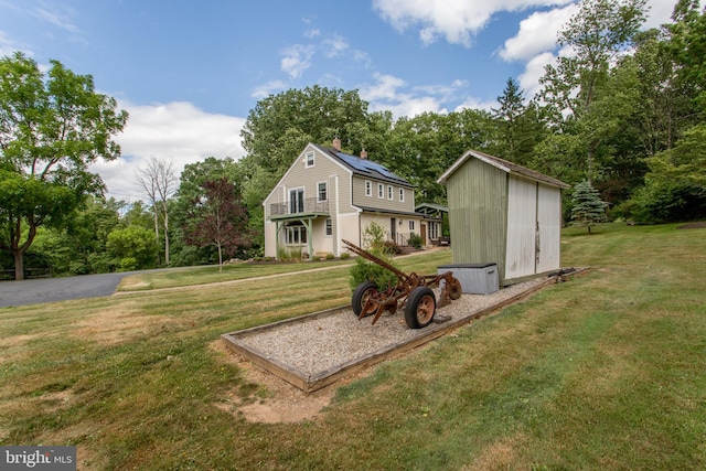 exterior space with a storage unit and a lawn