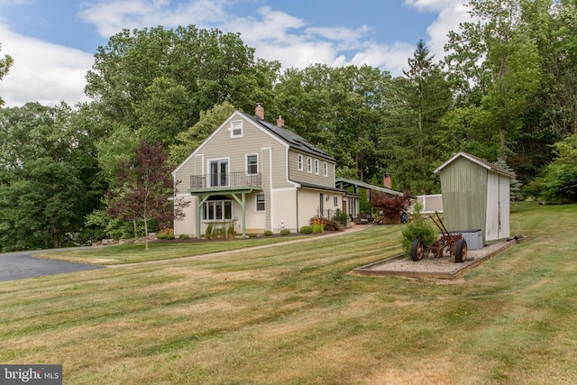 exterior space featuring a storage unit and a yard