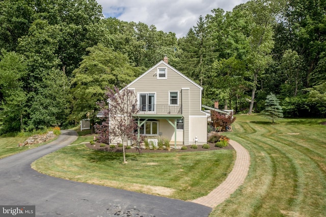 view of front property with covered porch and a front lawn