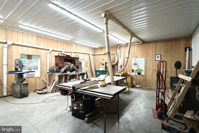 interior space with a workshop area and wooden walls